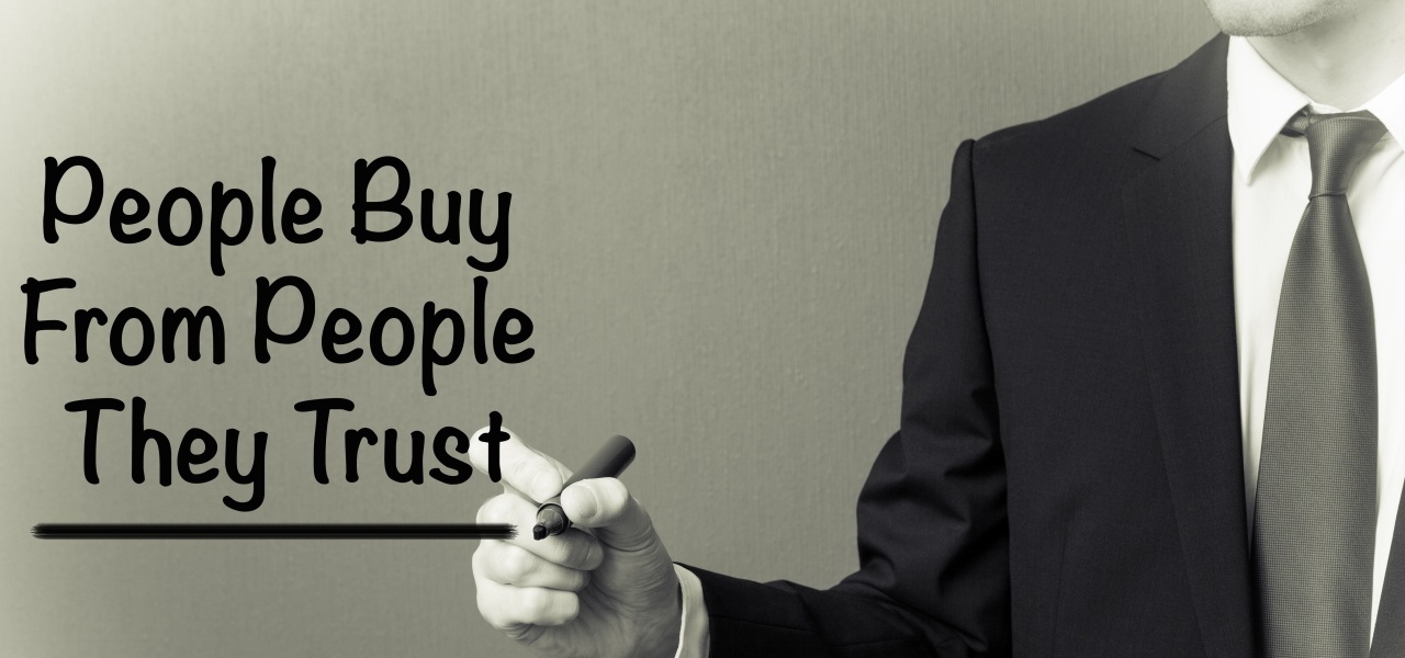man writing people buy from people they trust